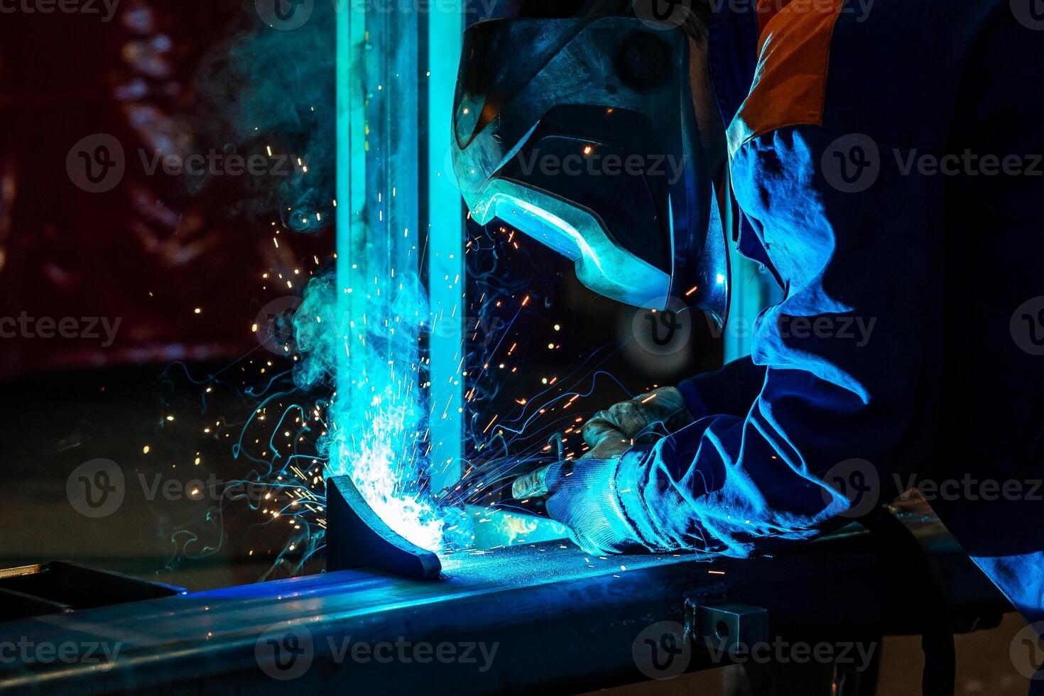 Skillful metal worker working with arc welding machine in factory while wearing safety equipment Metalwork manufacturing and construction maintenance service by manual skill labor concept photo