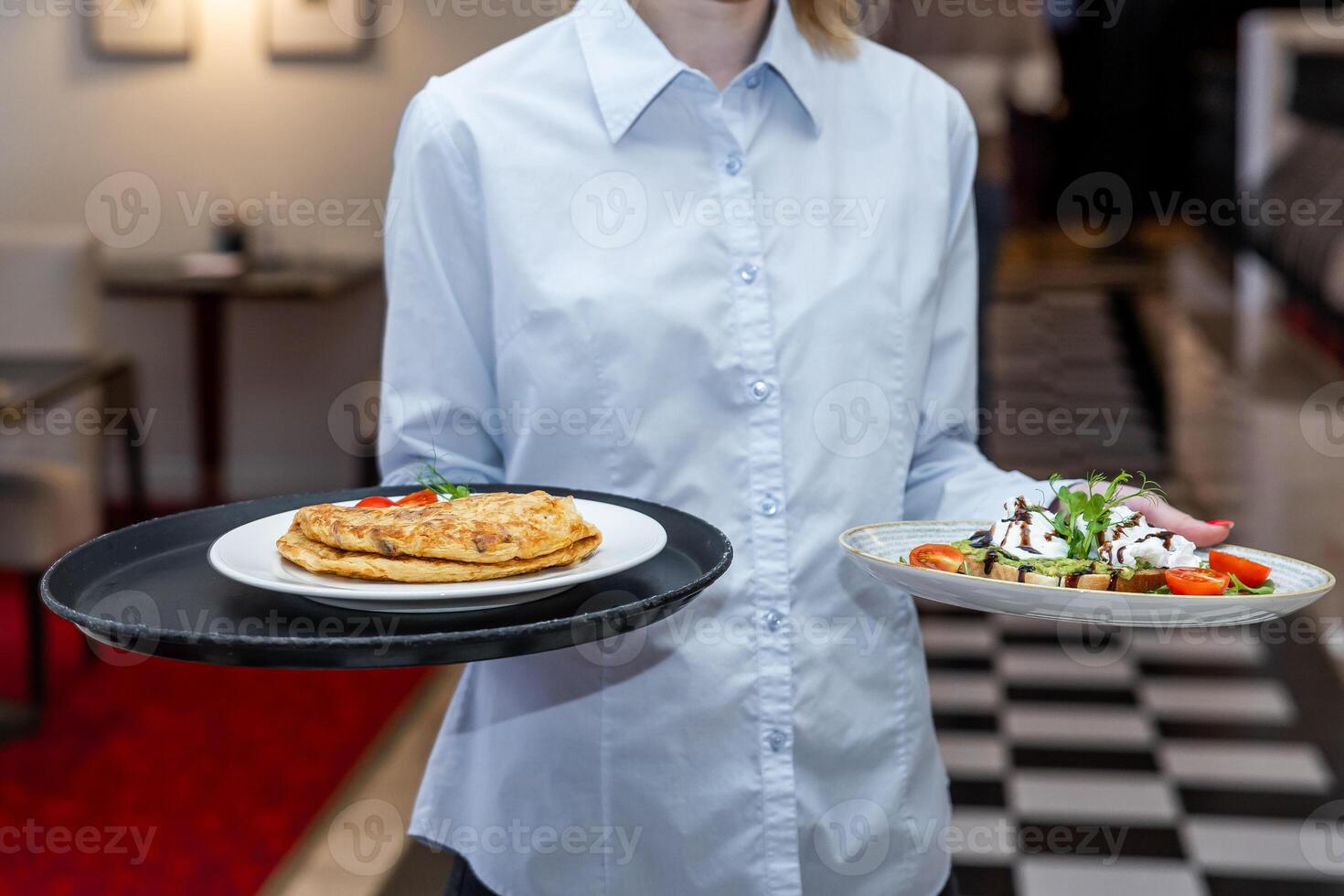 Professional Waitress Serving Omelette and Avocado Toast in a Hotel photo