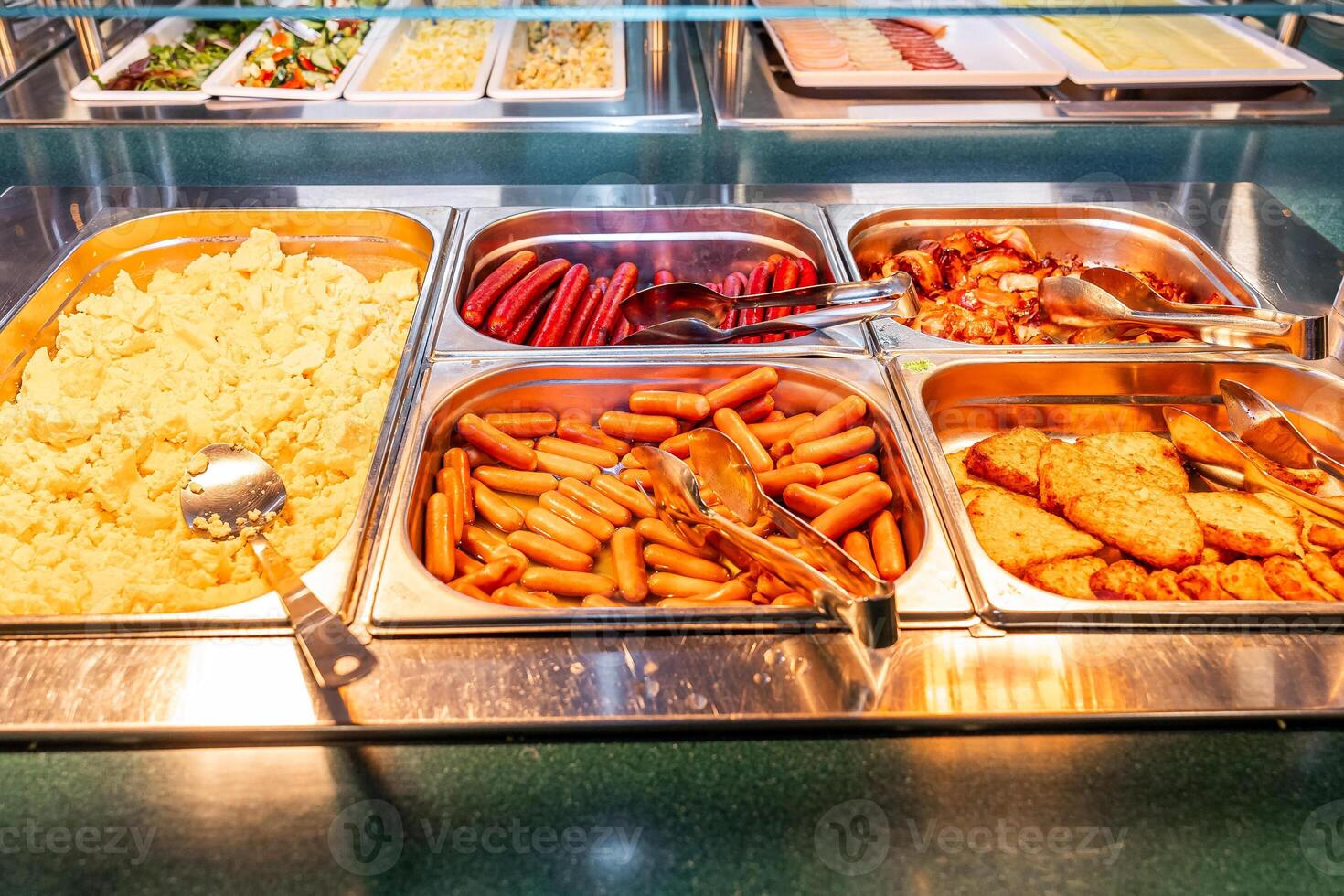 Hot Breakfast Selection with Scrambled Eggs and Sausages at Buffet photo