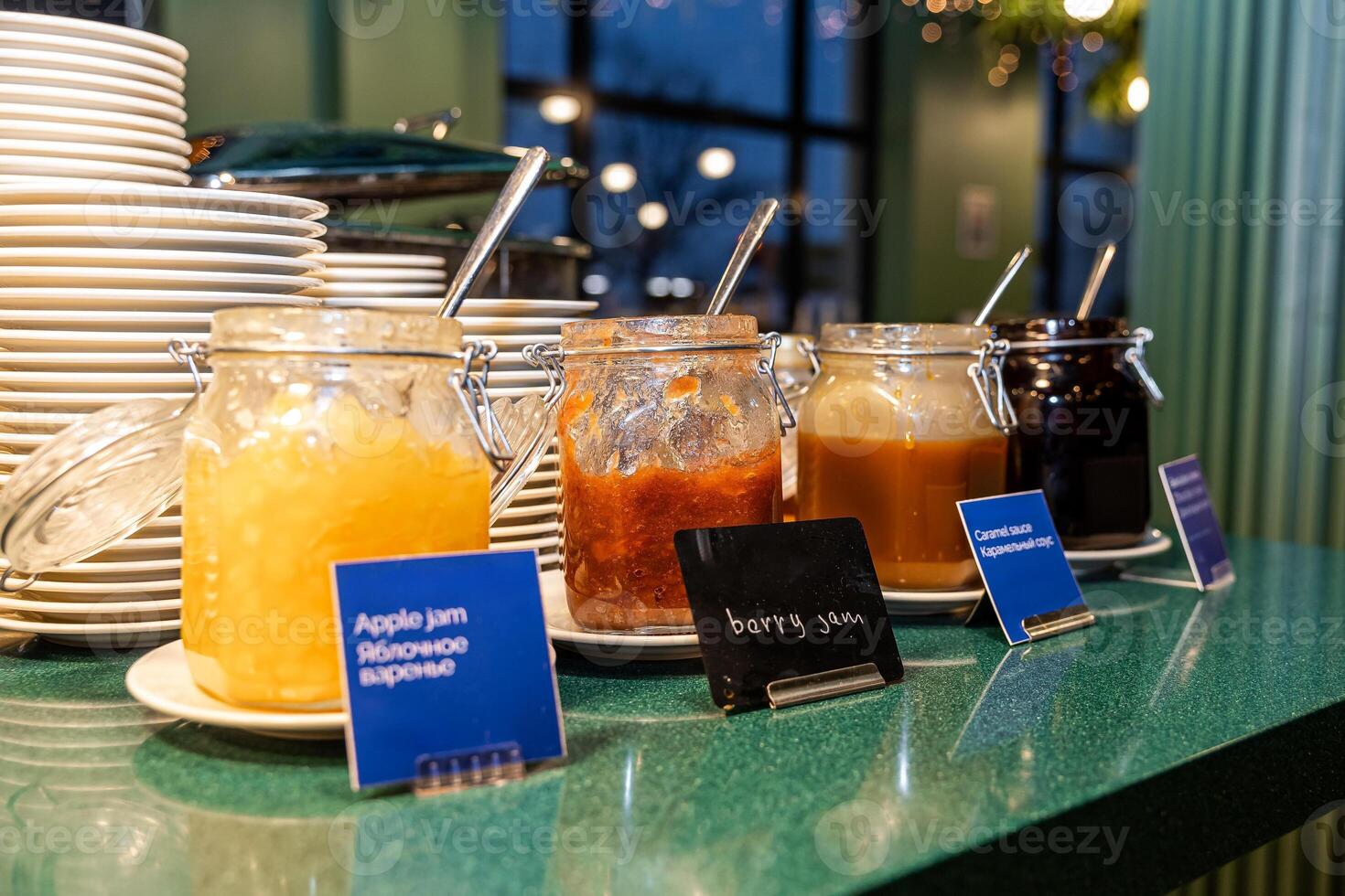 Array of Homemade Jams and Honey in Glass Jars at Buffet in hotel photo