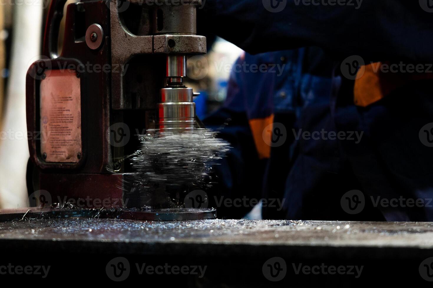 Close up of hole drilling process, metal shavings around drill Blurred background photo