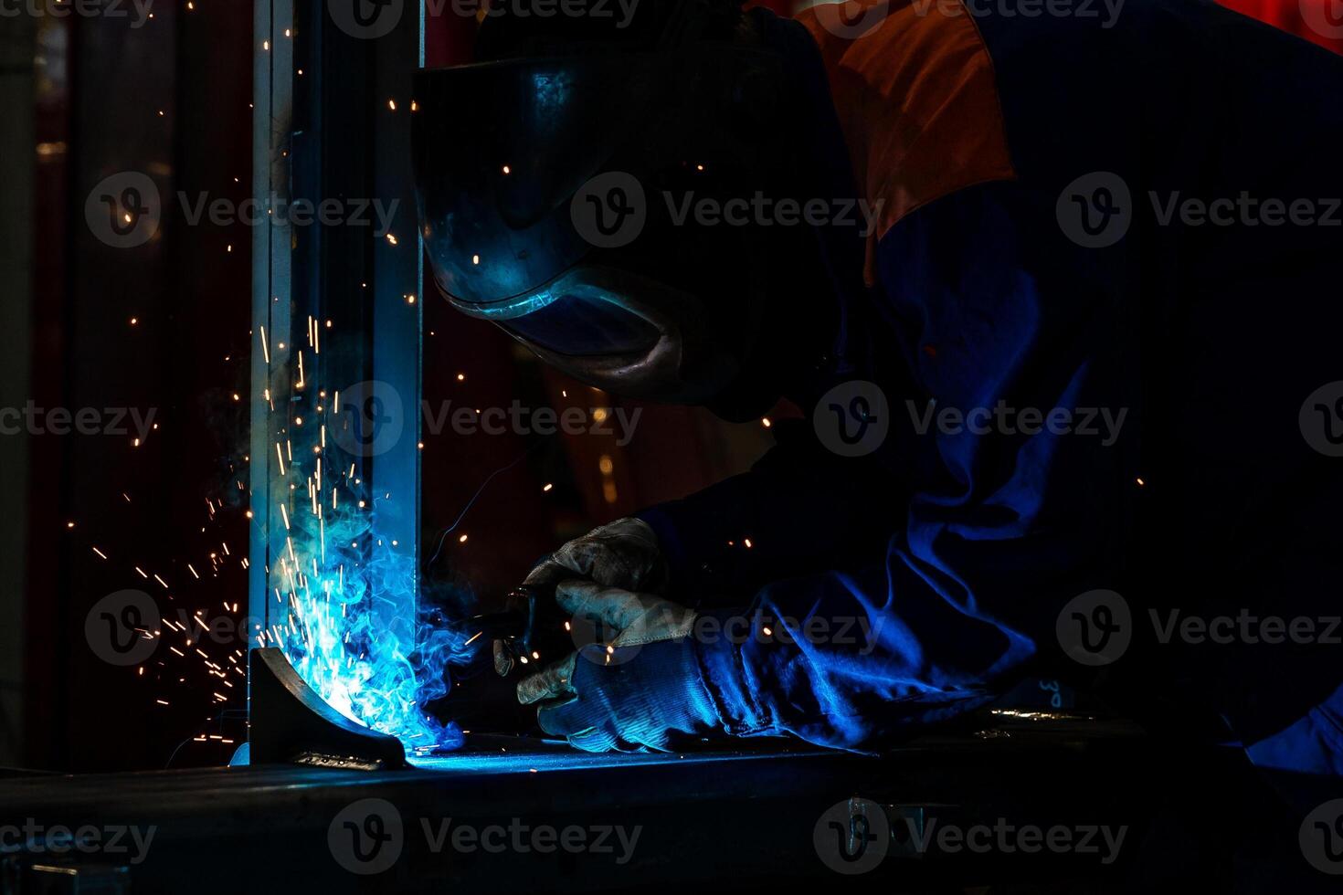 Skillful metal worker working with arc welding machine in factory while wearing safety equipment Metalwork manufacturing and construction maintenance service by manual skill labor concept photo