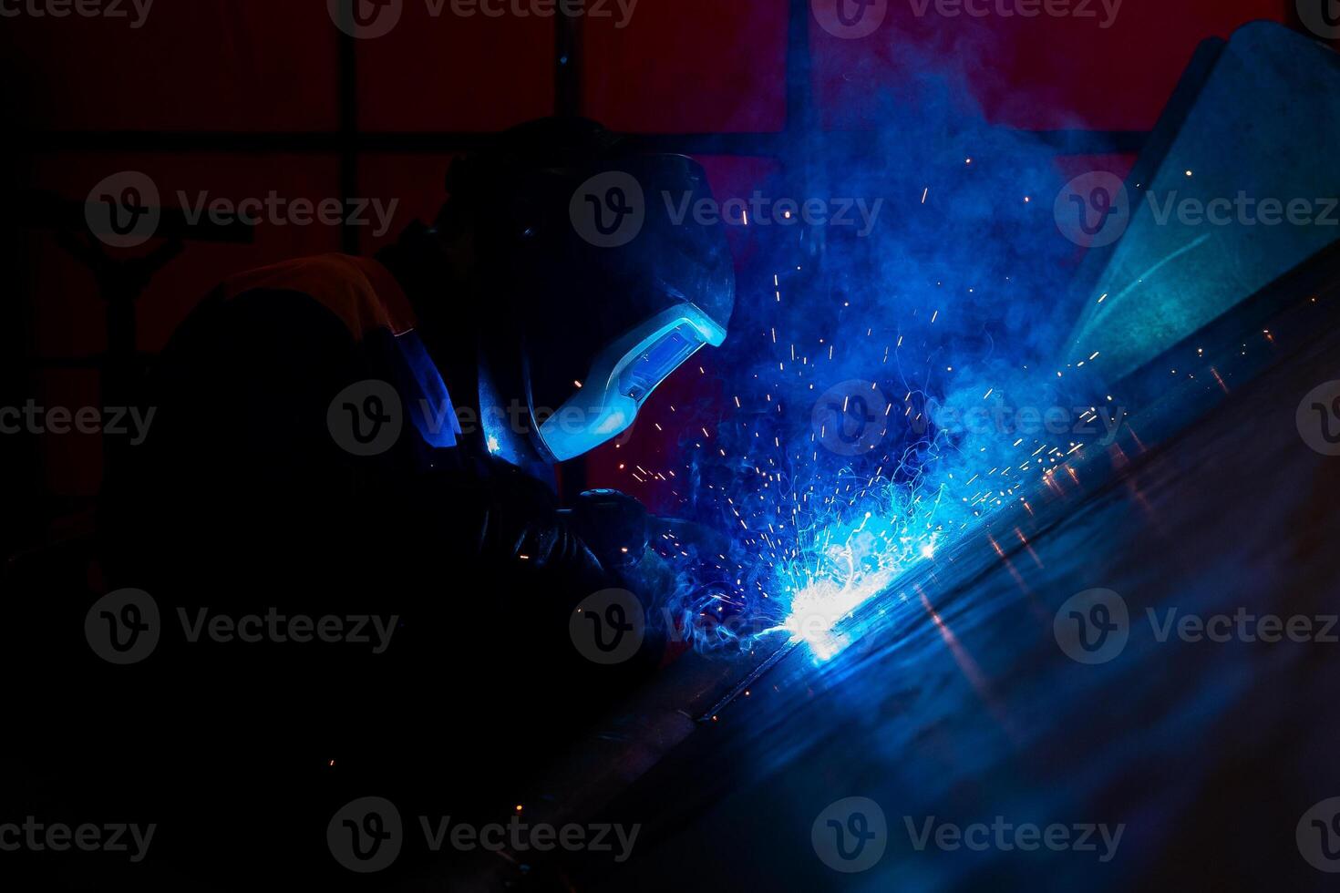 Skillful metal worker working with arc welding machine in factory while wearing safety equipment Metalwork manufacturing and construction maintenance service by manual skill labor concept photo
