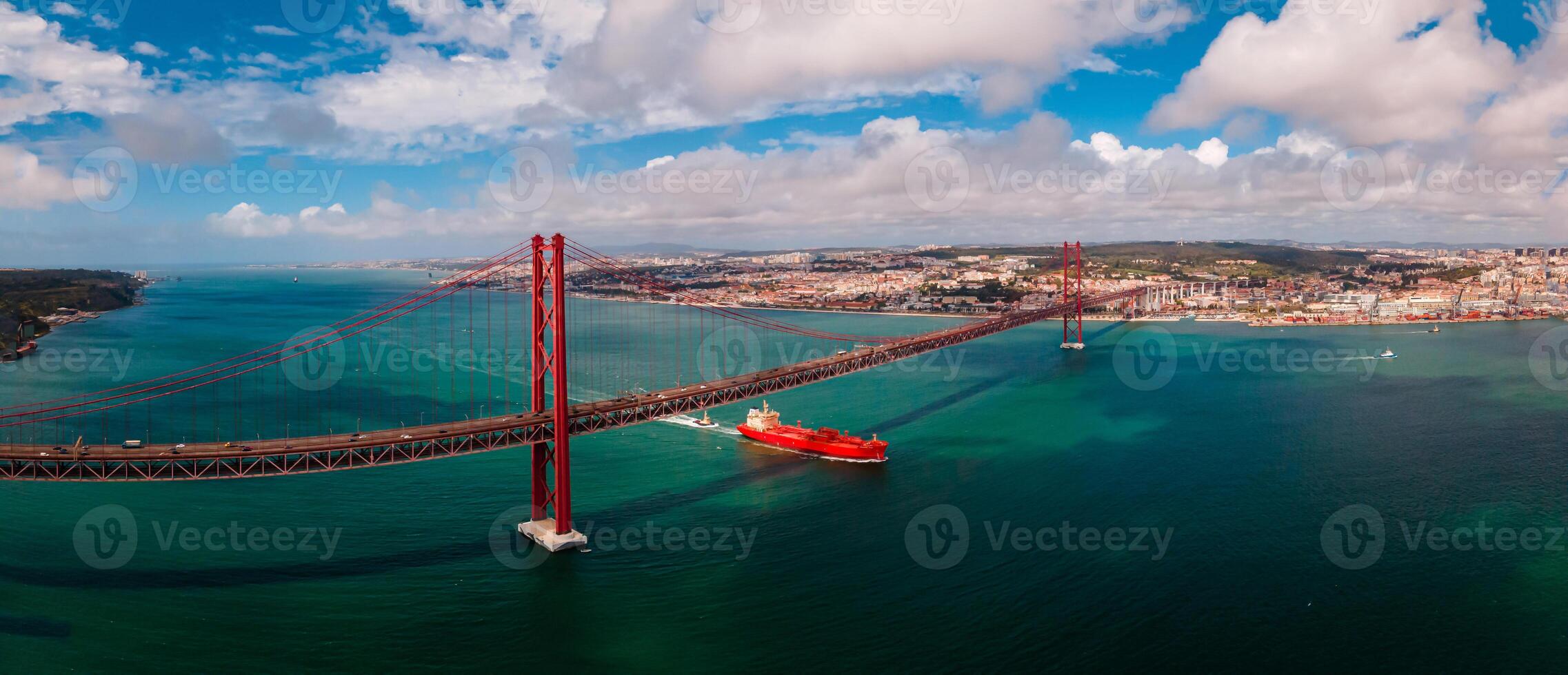 Lisbon, Portugal View of 25 de Abril Bridge famous tourist landmark of Lisbon connecting Lisboa and Almada on Setubal Peninsula over Tagus river . photo