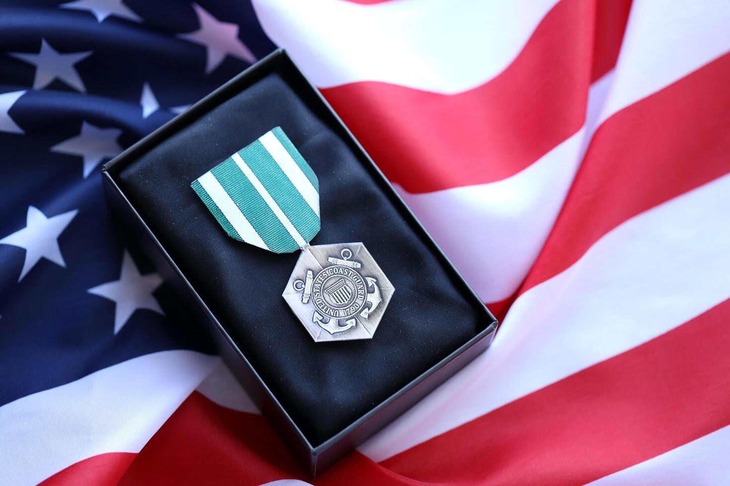 KYIV, UKRAINE - JULY 10, 2024 The Coast Guard Commendation medal. United States military award medal with ribbon and pin. Handmade paper theater props photo