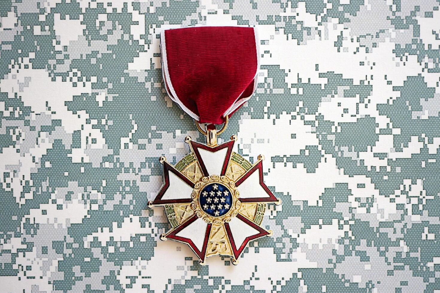 KYIV, UKRAINE - JULY 10, 2024 US Legion of Merit medal. United States military award medal with ribbon and pin. Handmade paper theater props photo