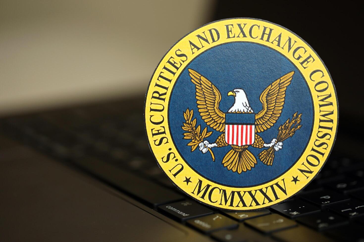 KYIV, UKRAINE - JUNE 26, 2024 U.S. Securities and Exchange Commission coat of arms sticker on silver laptop photo