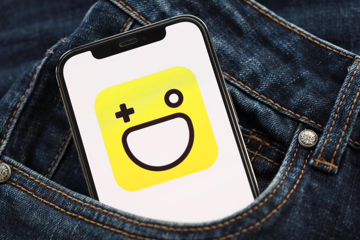 KYIV, UKRAINE - APRIL 1, 2024 Hago icon on smartphone display screen in jeans pocket photo