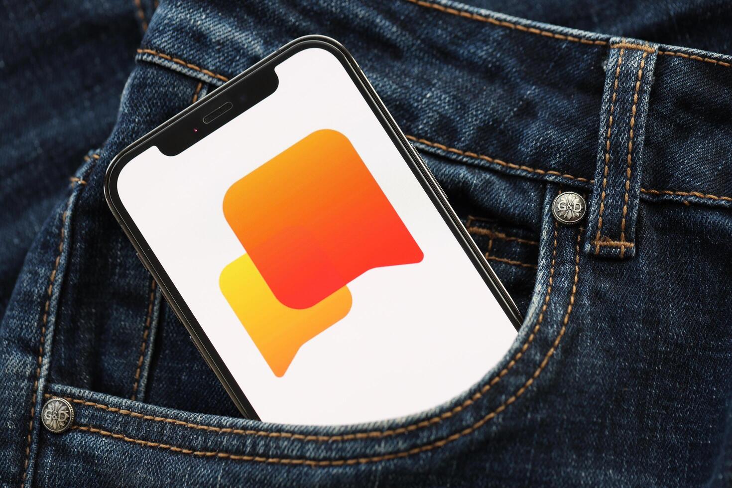 KYIV, UKRAINE - APRIL 1, 2024 Helo icon on smartphone display screen in jeans pocket photo