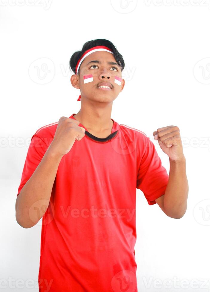 Indonesian man celebrate independence day with excited expression, Adult Asian man screaming enthusiast with both hands clenched photo