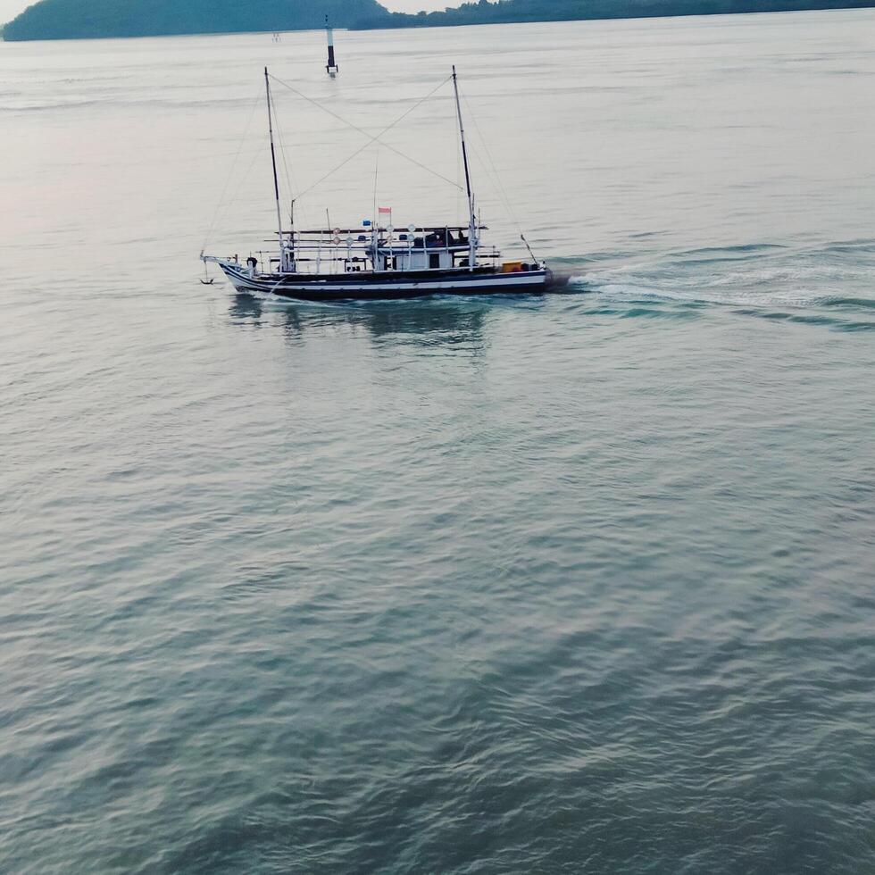 view of a ship in the middle of the ocean with a beautiful sky decoration photo