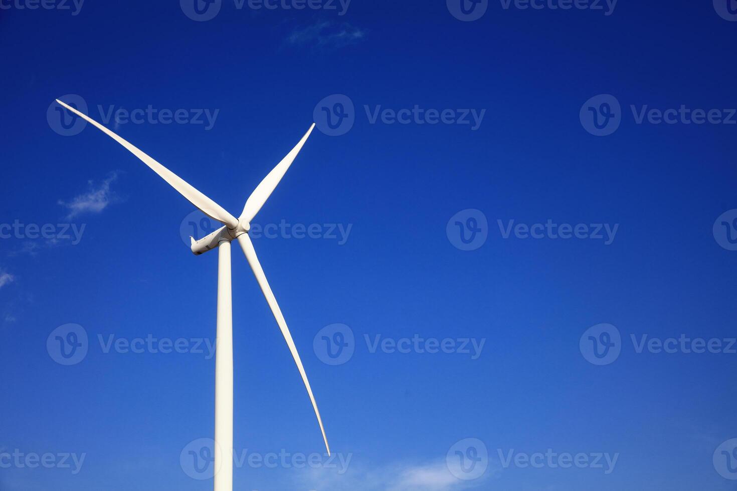 the propeller of wind turbine against the blue sky and cloudy in background photo