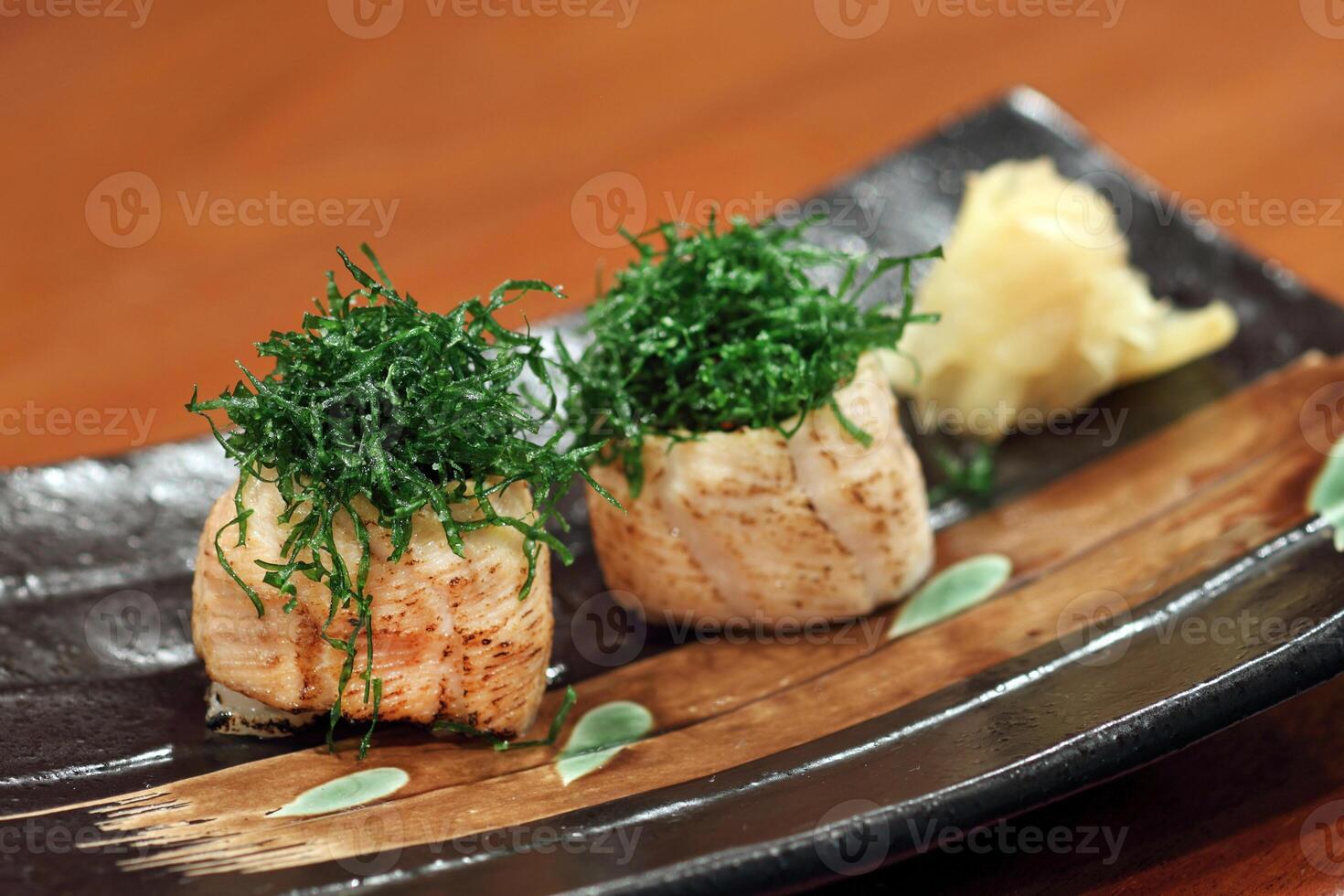 Sushi Joe Crispy Kale, salmon roll, cream cheese, fried kale and chives on plate photo