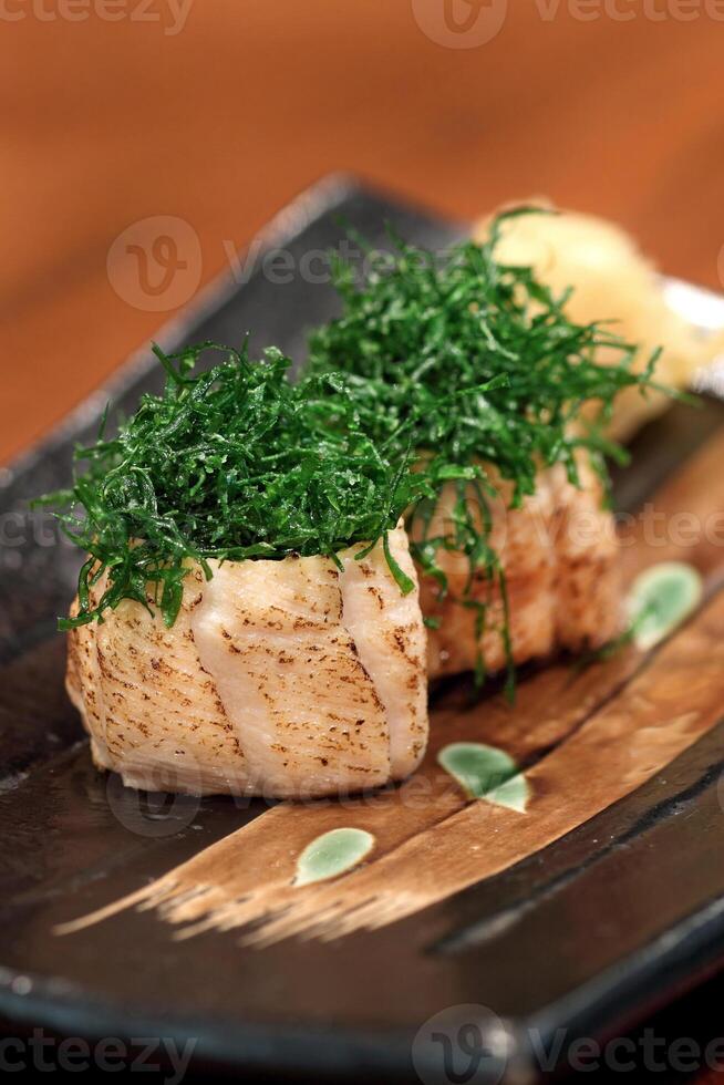 Sushi Joe Crispy Kale, salmon roll, cream cheese, fried kale and chives on plate photo