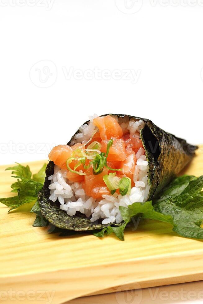 Salmon temaki, Japanese delicacy with sushi rice, chopped fresh salmon and nori seaweed sheets photo