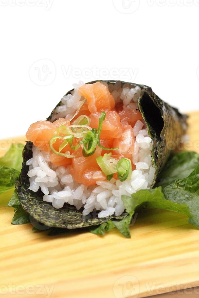 Salmon temaki, Japanese delicacy with sushi rice, chopped fresh salmon and nori seaweed sheets photo