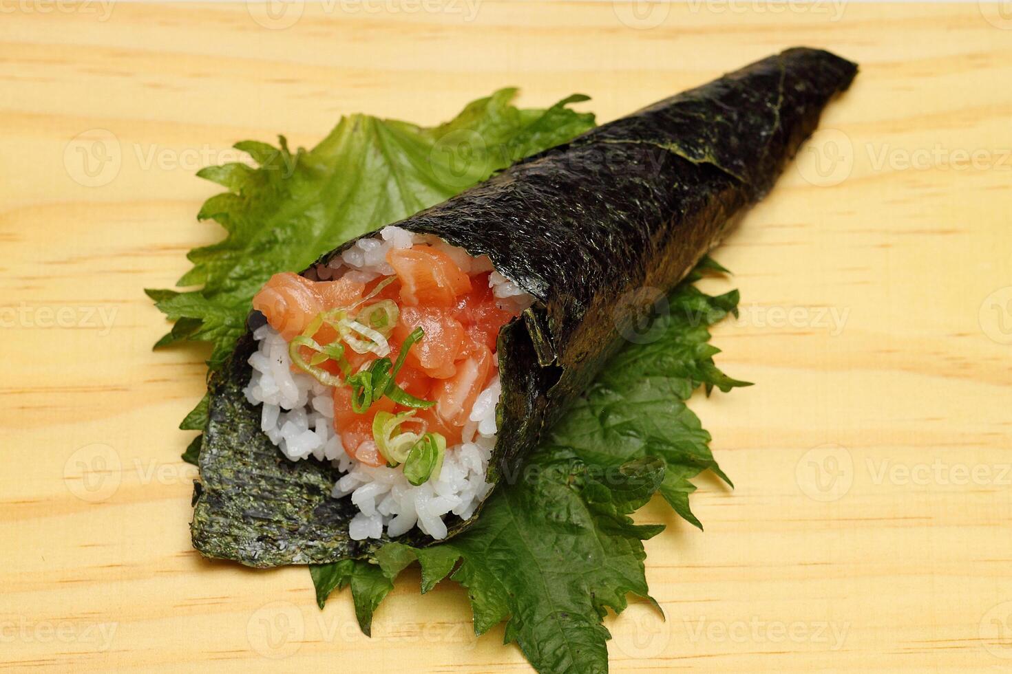 Salmon temaki, Japanese delicacy with sushi rice, chopped fresh salmon and nori seaweed sheets photo