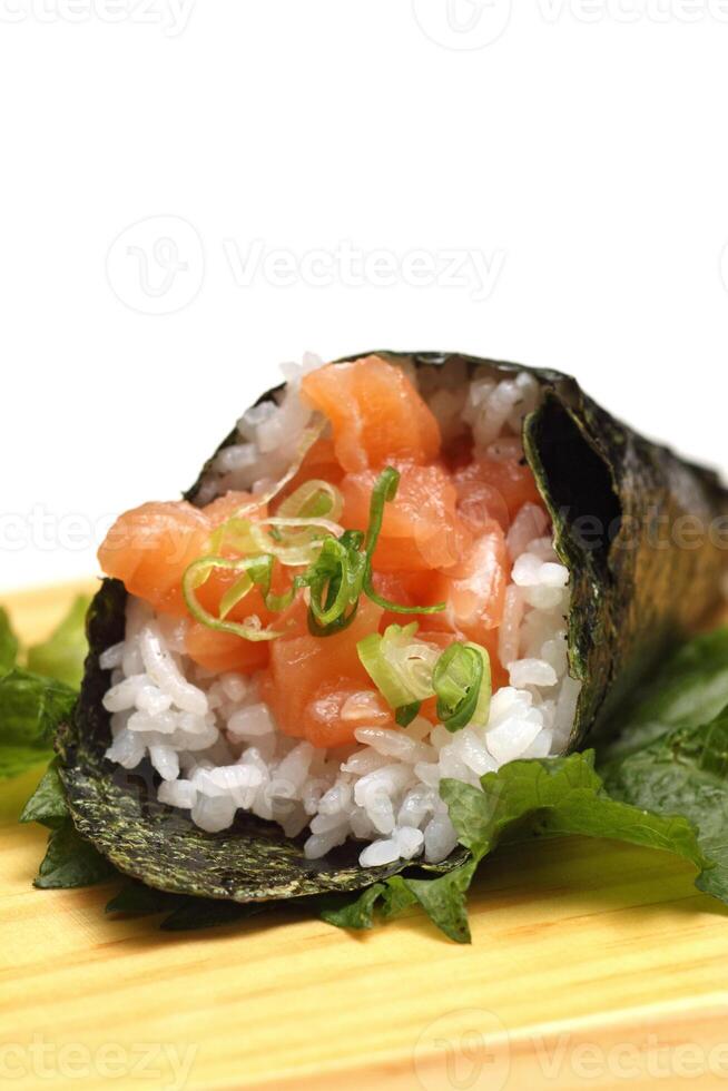 Salmon temaki, Japanese delicacy with sushi rice, chopped fresh salmon and nori seaweed sheets photo