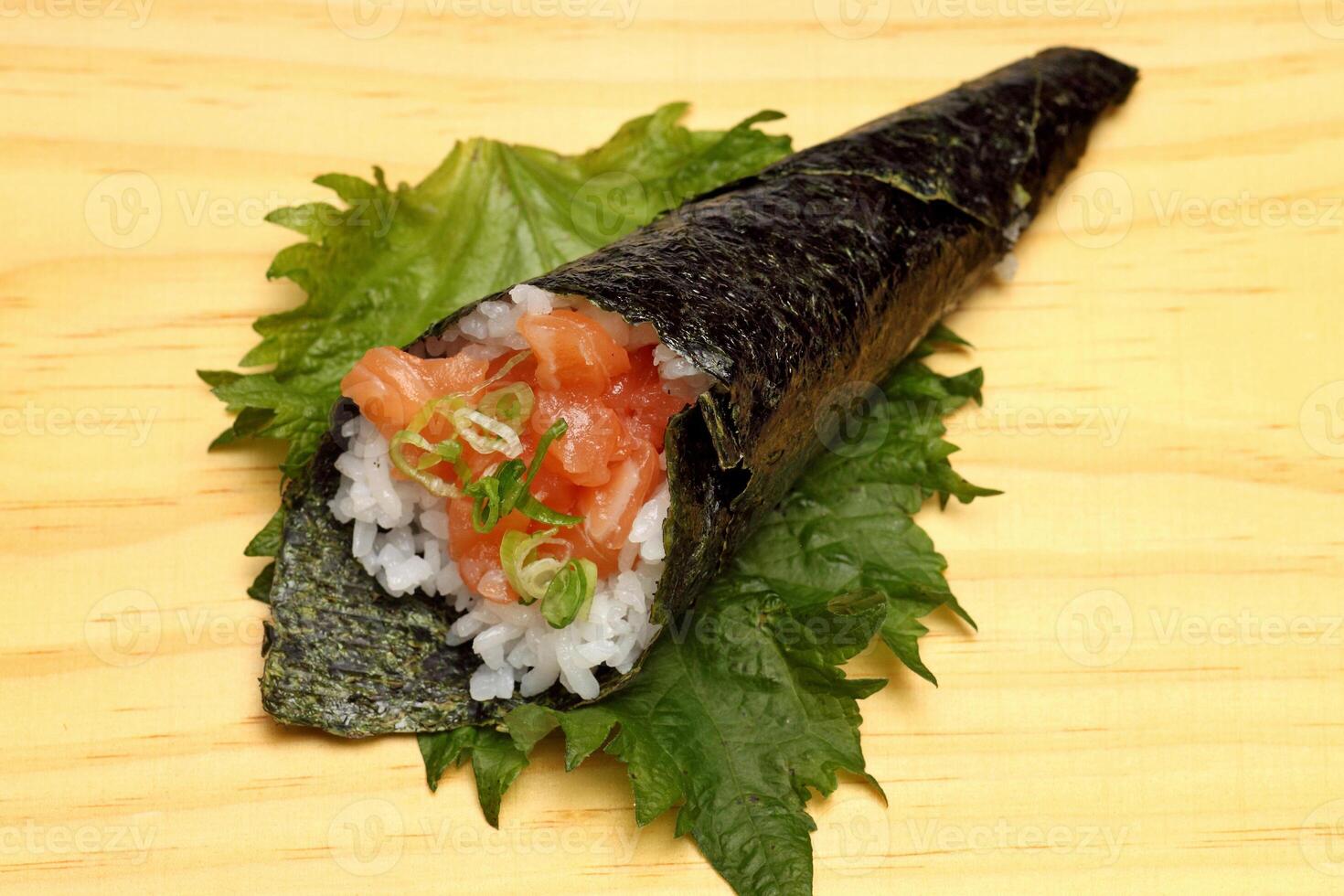 Salmon temaki, Japanese delicacy with sushi rice, chopped fresh salmon and nori seaweed sheets photo