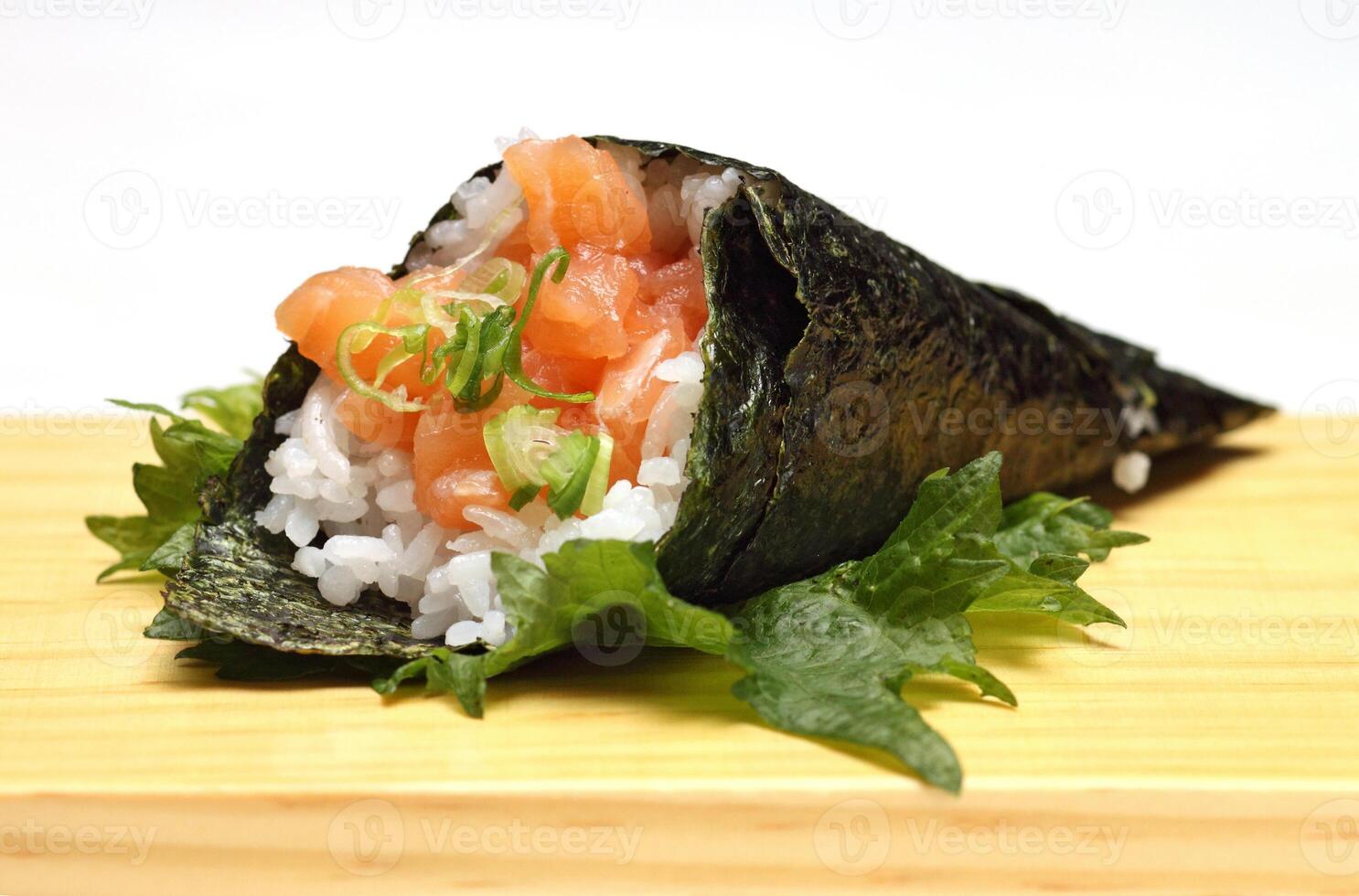 Salmon temaki, Japanese delicacy with sushi rice, chopped fresh salmon and nori seaweed sheets photo