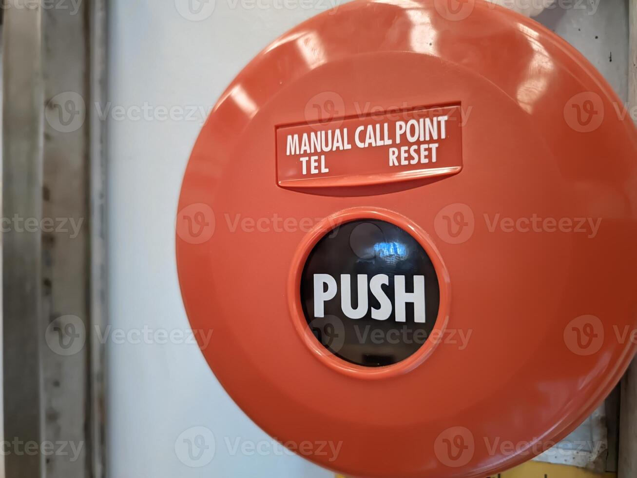 Manual call point tool for fire alarm system, red installed on the wall photo