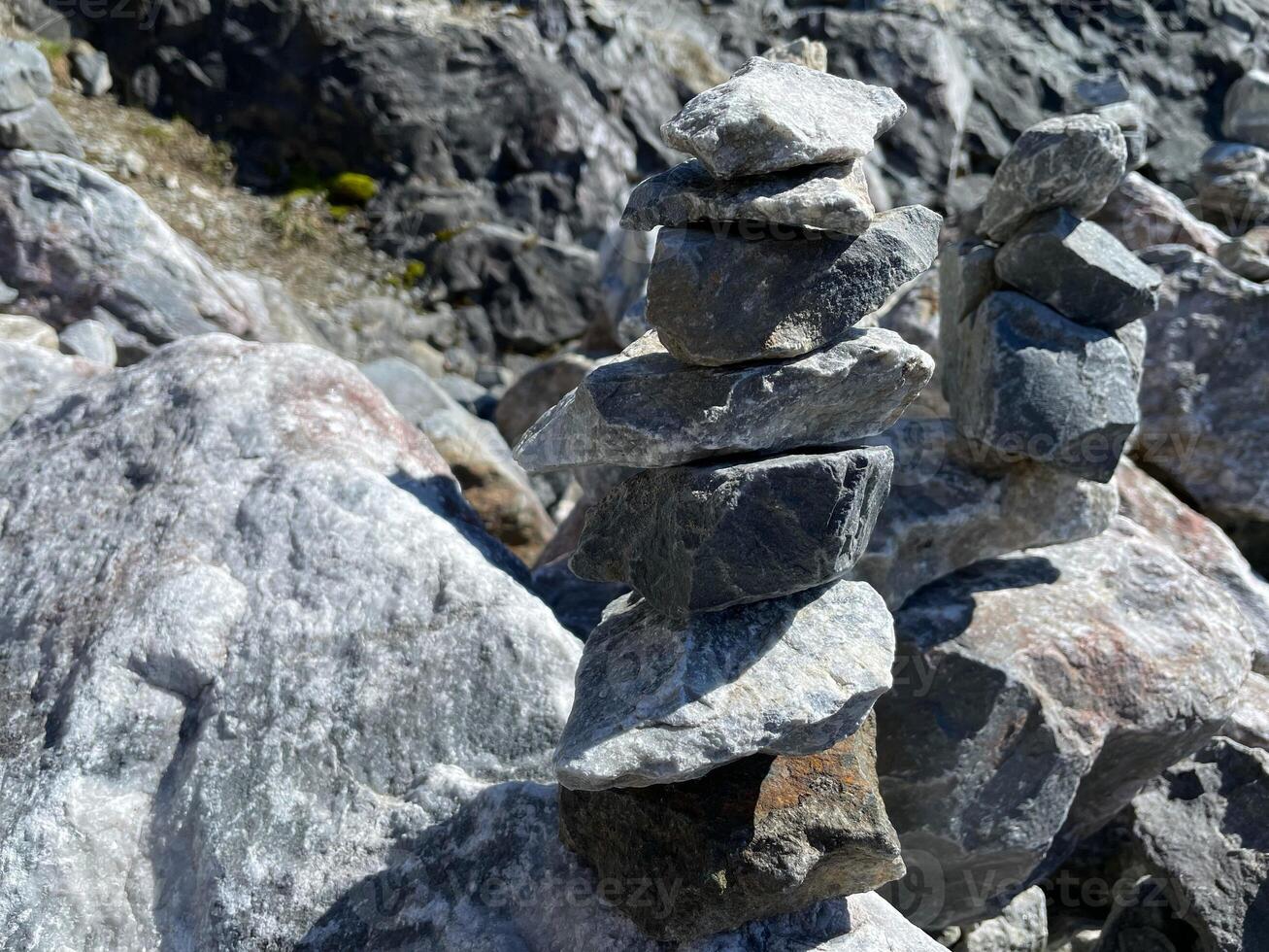 pyramid of balanced stones. tower of minerals in a rocky mountainous area. natural horizontal background. photography was taken in Republic of Karelia in Russia photo