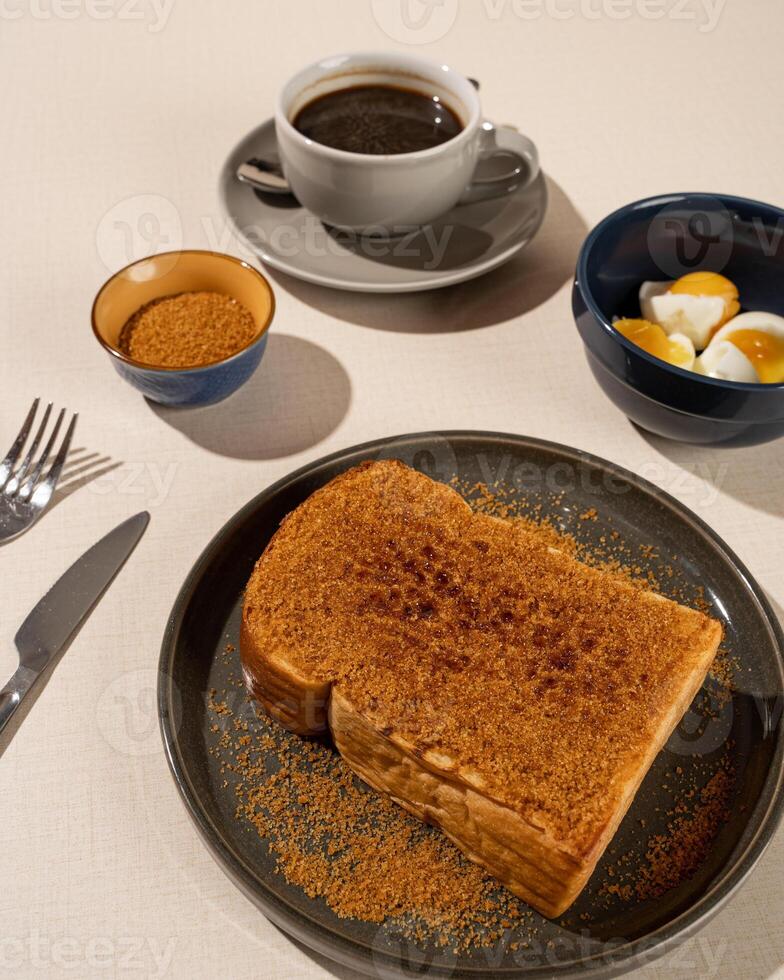 Roti Bakar is a typical grilled Indonesian sandwich, consisting of two slices of bread served with eggs and coffee photo