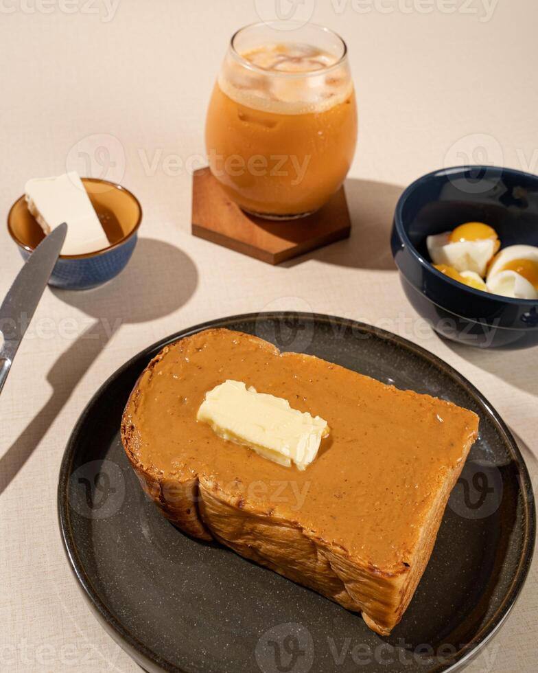 Roti Bakar is a typical grilled Indonesian sandwich, consisting of two slices of bread and filling, served with Teh Tarik and boiled egg. photo