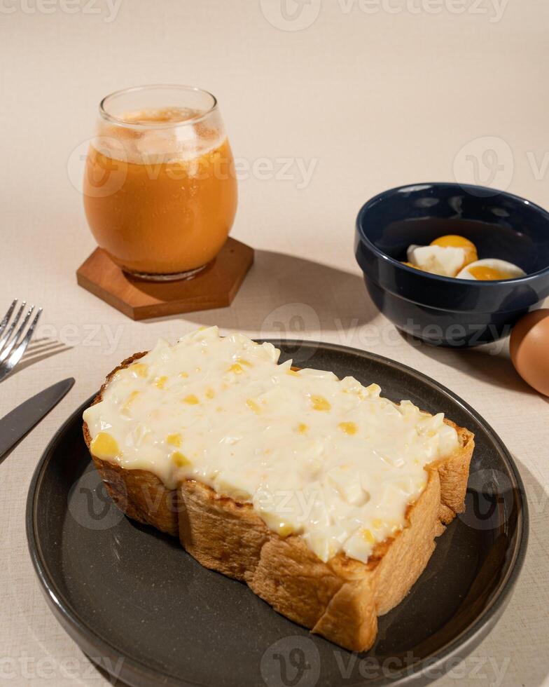 Roti Bakar is a typical grilled Indonesian sandwich, consisting of two slices of bread and filling, served with Teh Tarik and boiled egg. photo