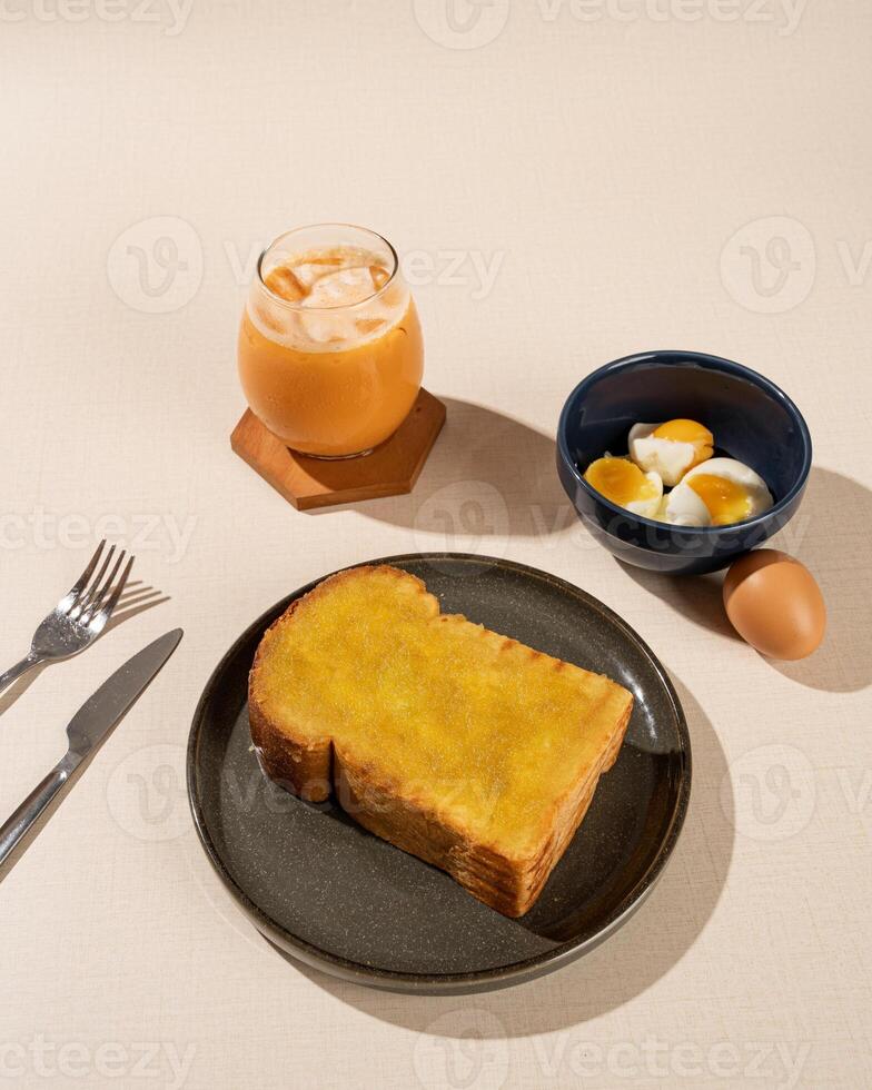 Roti Bakar is a typical grilled Indonesian sandwich, consisting of two slices of bread and filling, served with Teh Tarik and boiled egg. photo