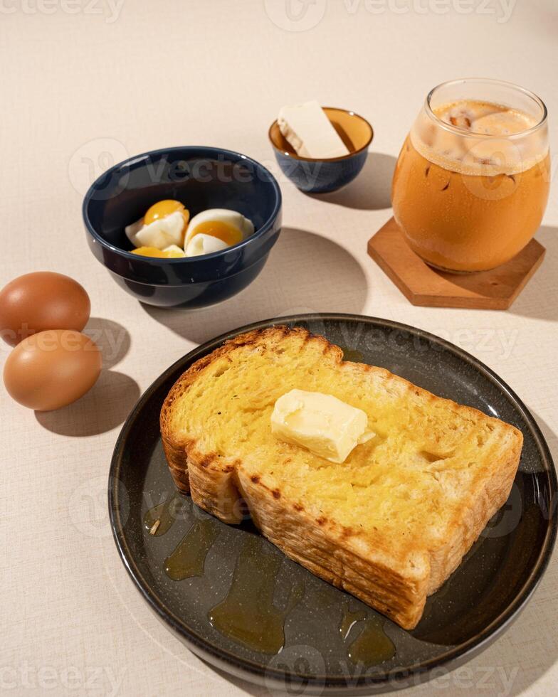 Roti Bakar is a typical grilled Indonesian sandwich, consisting of two slices of bread and filling, served with Teh Tarik and boiled egg. photo