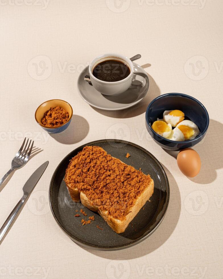 Roti Bakar is a typical grilled Indonesian sandwich, consisting of two slices of bread served with eggs and coffee photo