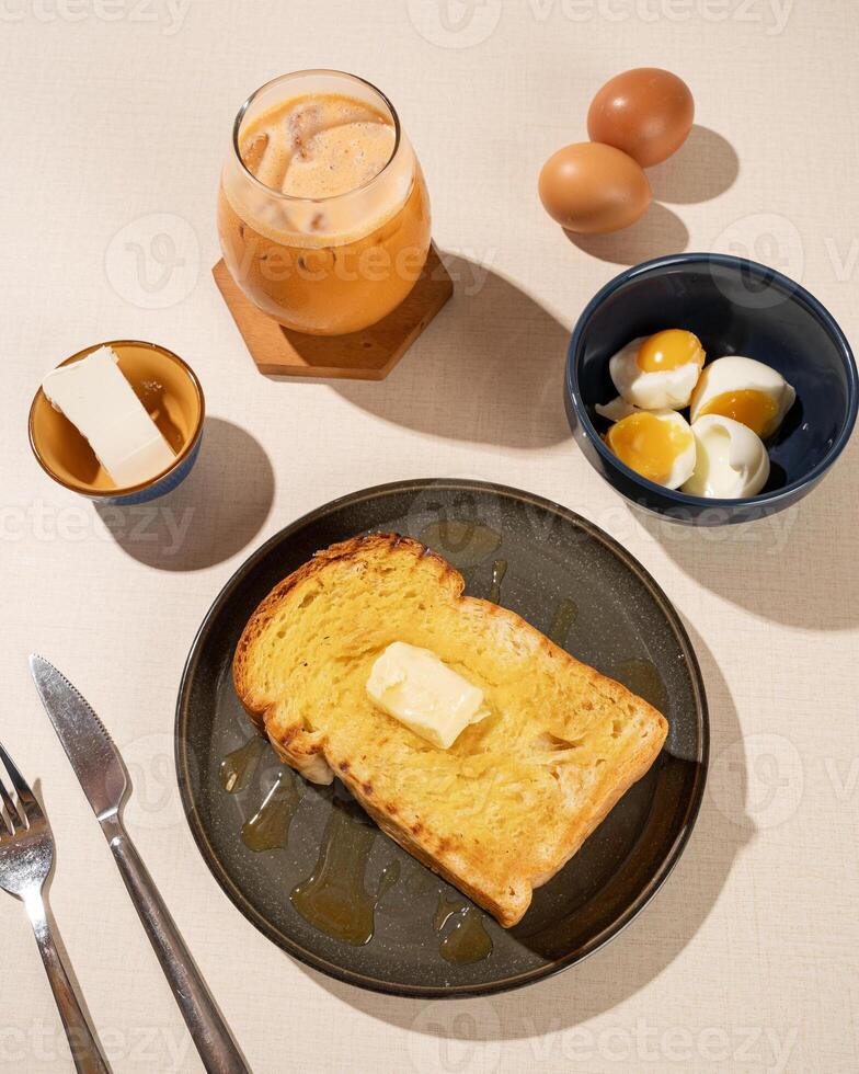 Roti Bakar is a typical grilled Indonesian sandwich, consisting of two slices of bread and filling, served with Teh Tarik and boiled egg. photo