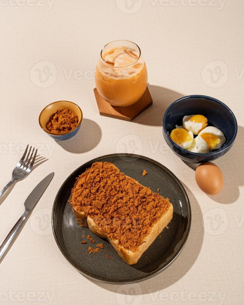 Roti Bakar is a typical grilled Indonesian sandwich, consisting of two slices of bread and filling, served with Teh Tarik and boiled egg. photo