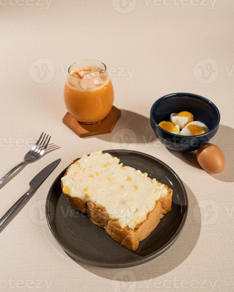 Roti Bakar is a typical grilled Indonesian sandwich, consisting of two slices of bread and filling, served with Teh Tarik and boiled egg. photo