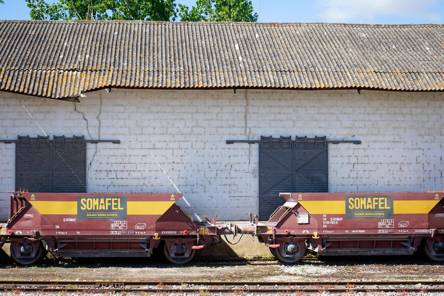 Portalegre, Portugal. May 19, 2024. Freight train wagons stationary at a railway station showcasing the industrial transport hub. photo