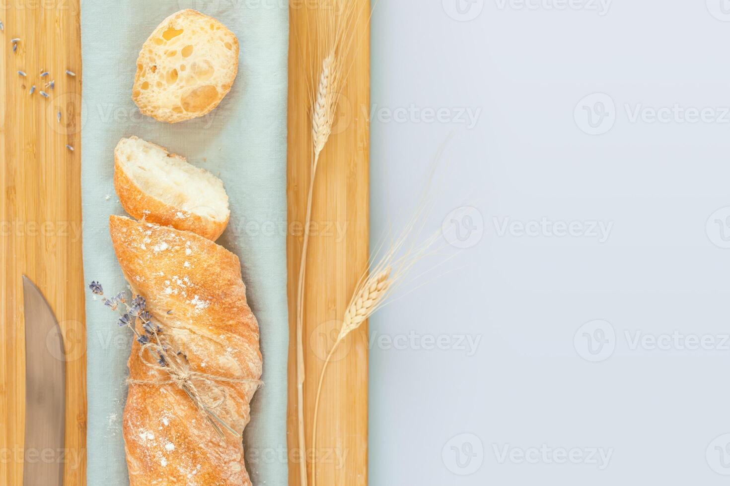 Sliced fresh crispy handmade French baguette with knife photo