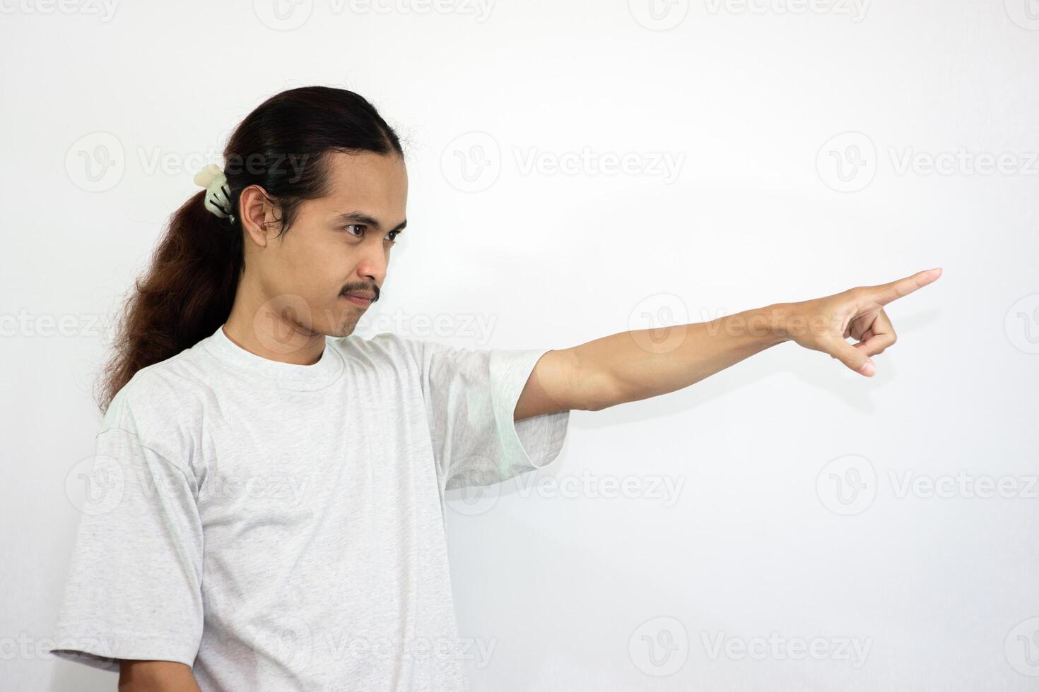 Upset and angry man with hand pointing to another direction, isolated on white background. photo