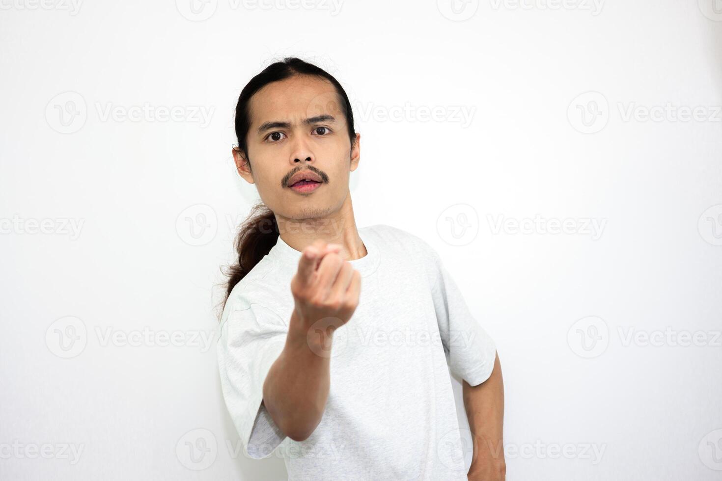 Upset and angry man with hand pointing at the camera, isolated on white background. photo