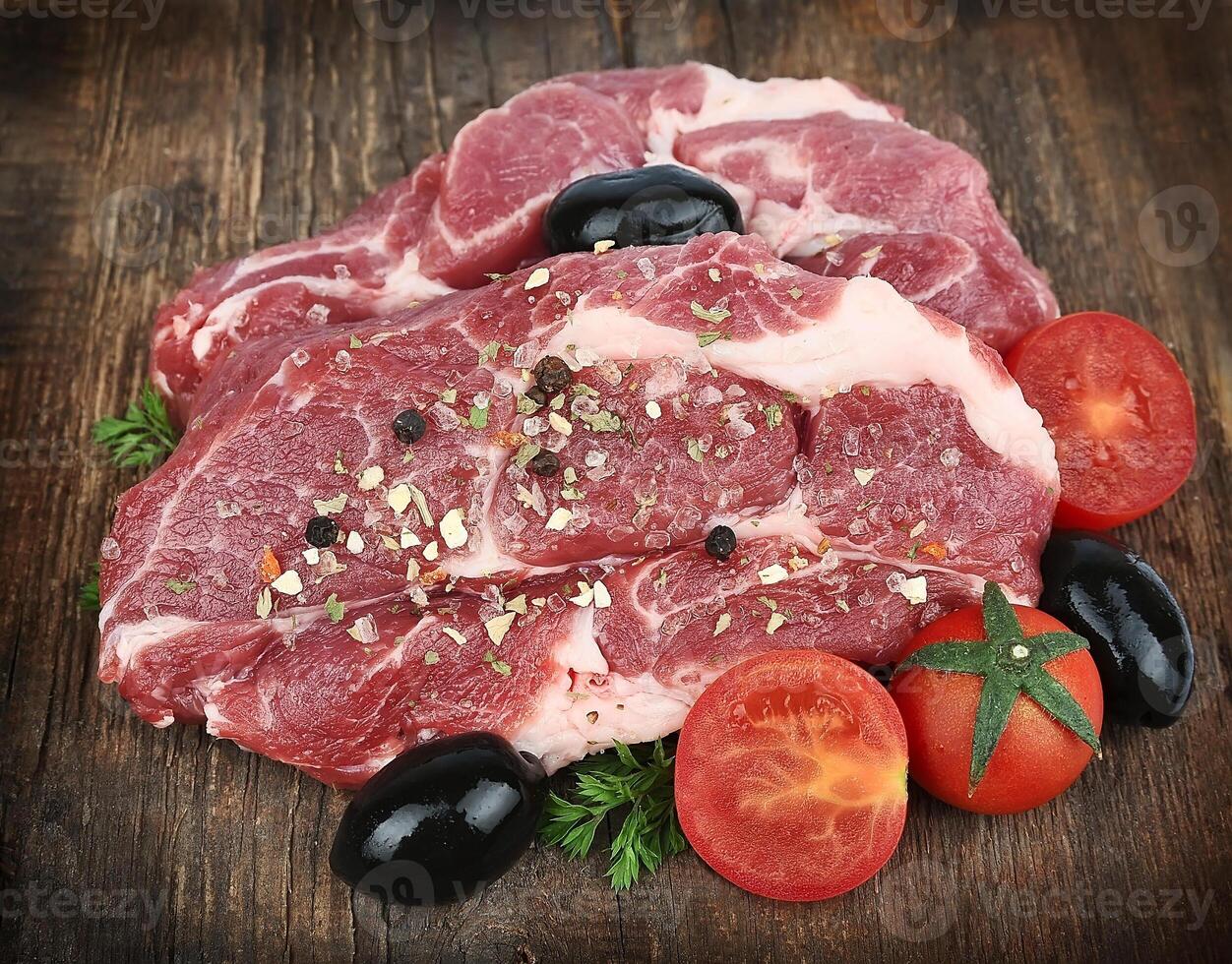 raw steak with spice photo