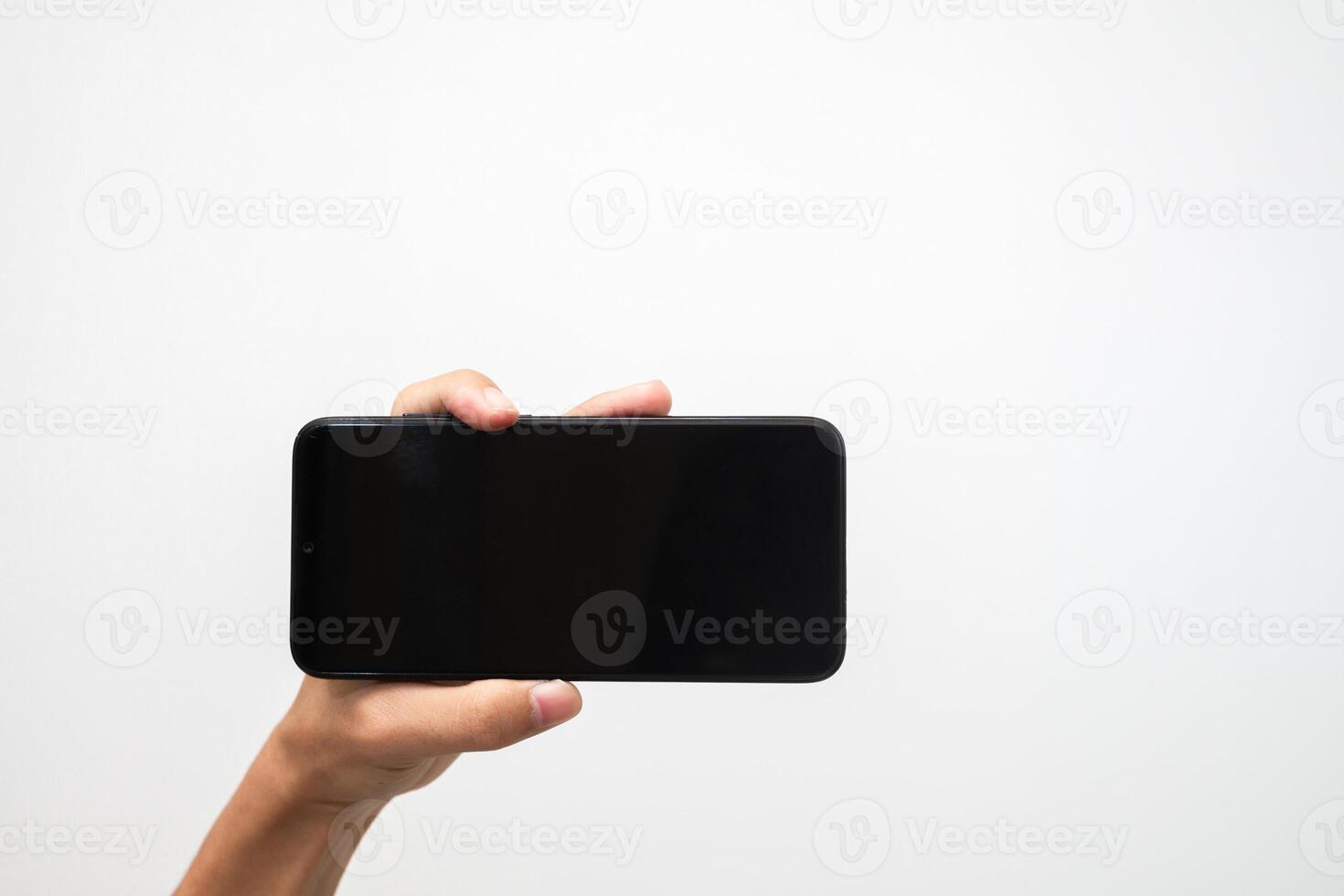 Man's hand holding a smart phone screen view from above. isolated in white background photo