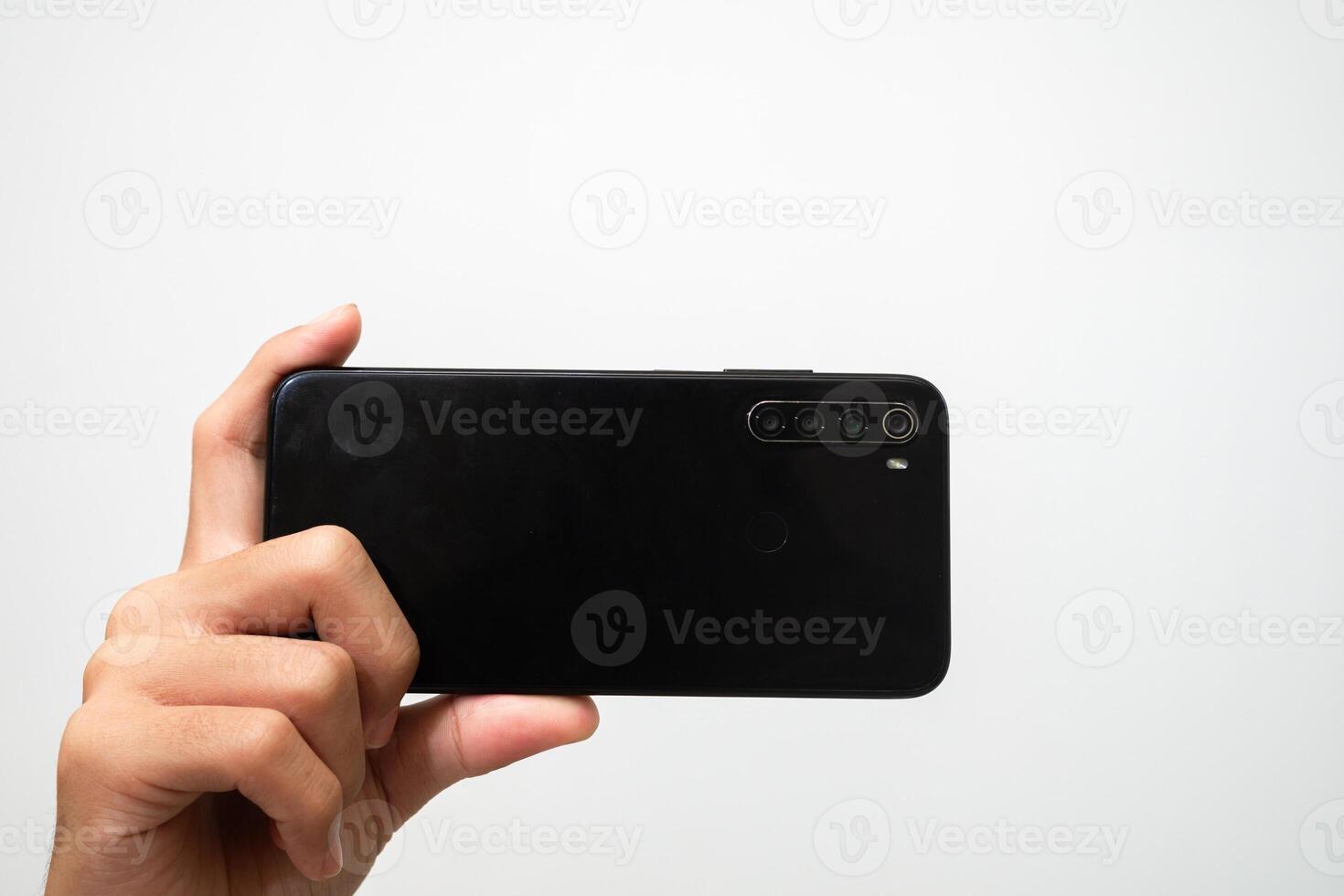 Man's hand holding a smart phone screen view from above. isolated in white background photo