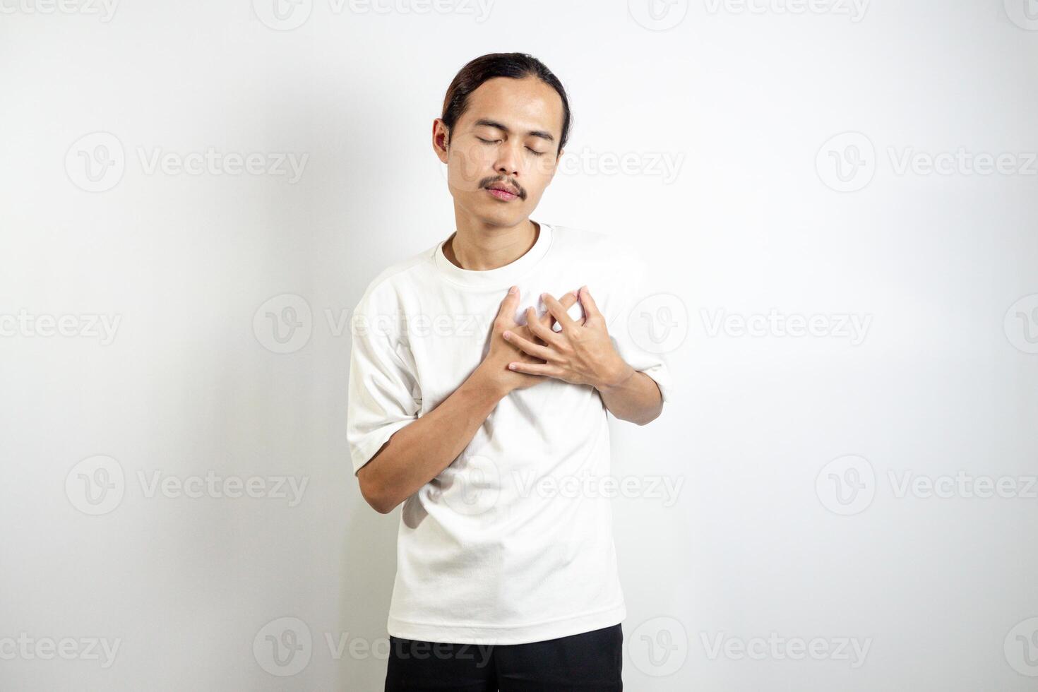A young man clutched his chest. Severe pain, shortness of breath, panic attacks, heart attacks, strokes. isolated in white background photo