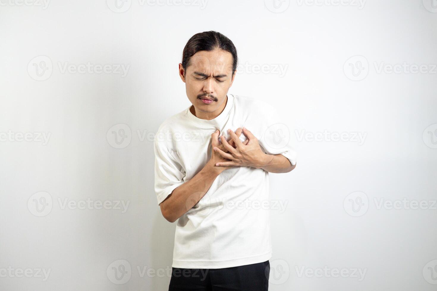 A young man clutched his chest. Severe pain, shortness of breath, panic attacks, heart attacks, strokes. isolated in white background photo