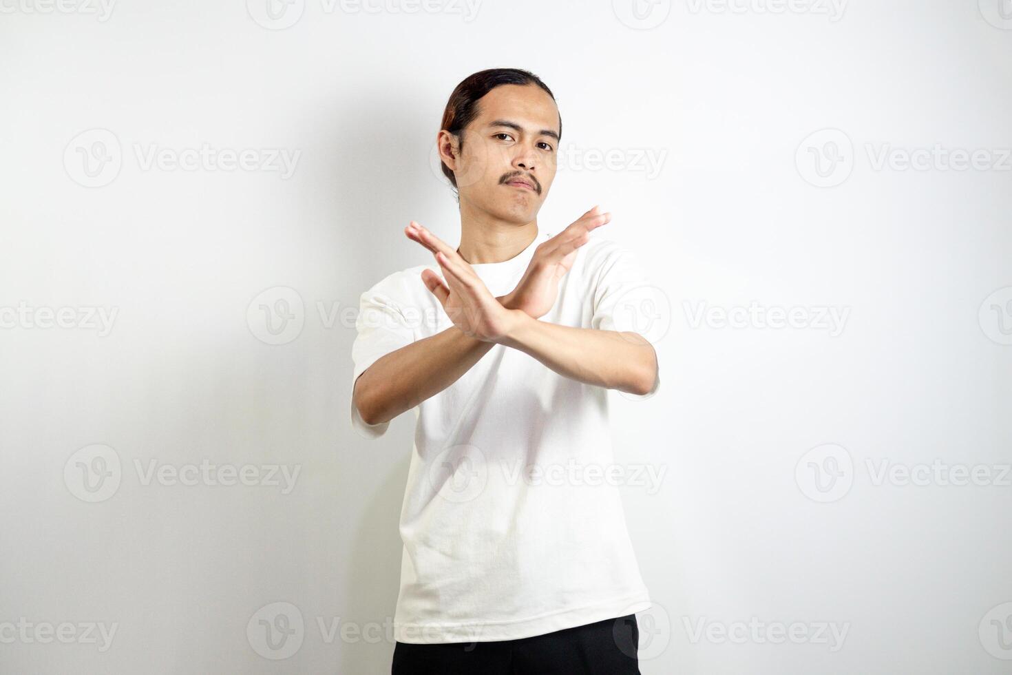 Young man wearing a white t-shirt. make movements not with your hands. crossed arms. There isn't any. sign isolated on white background photo