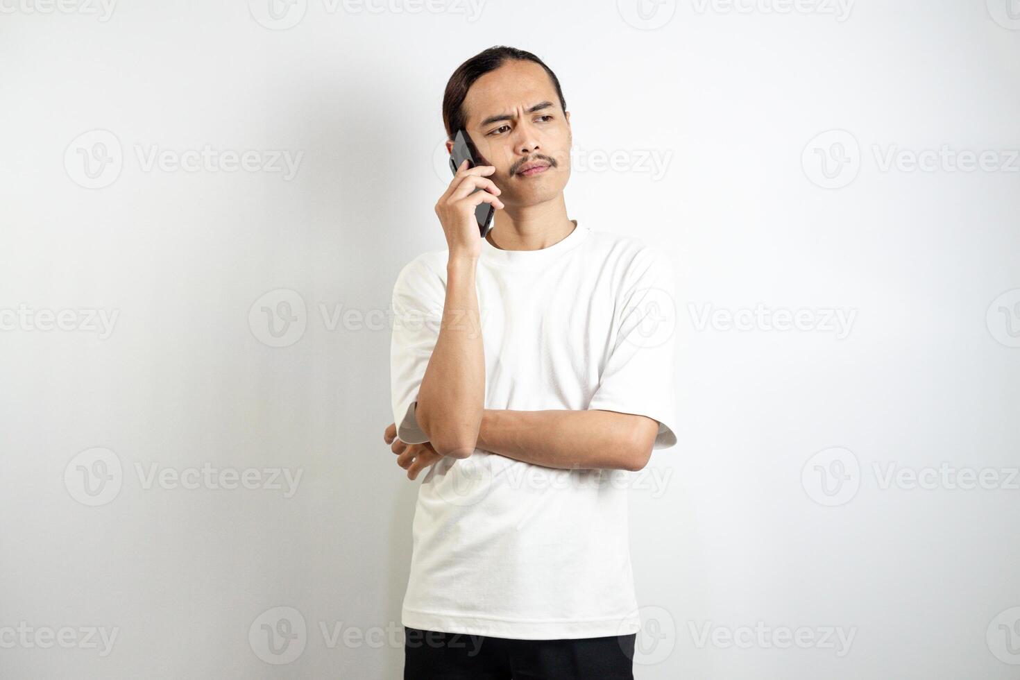 Asian man holding the phone. with a thoughtful expression. isolated in white background photo