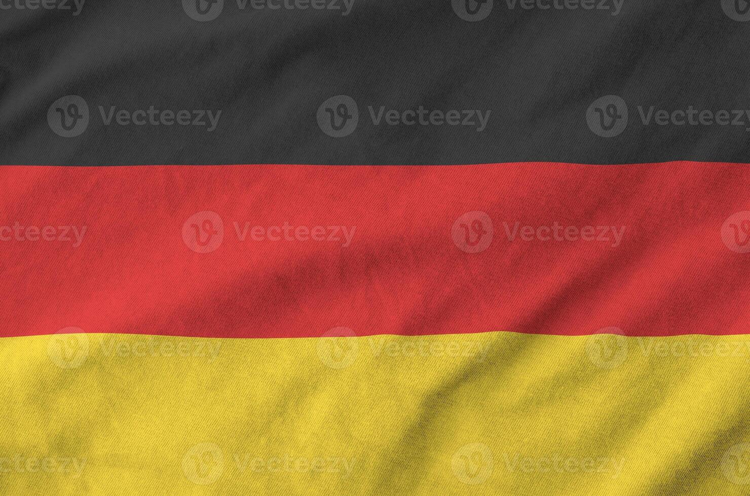 Germany flag depicted on folded wavy fabric of old cloth photo