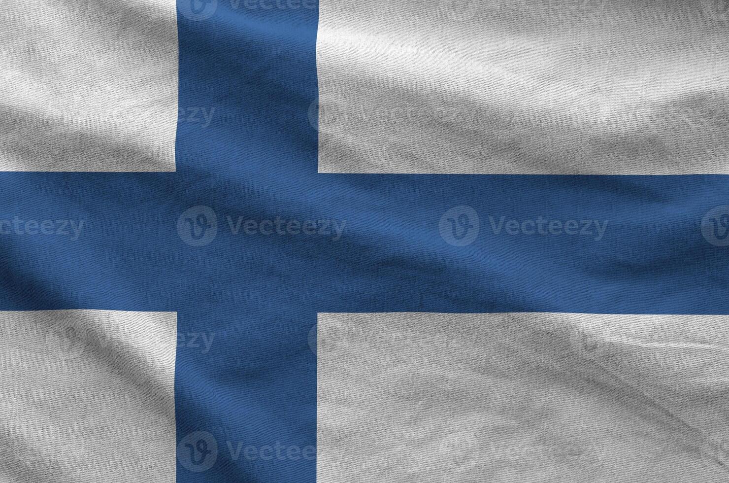 Finland flag depicted on folded wavy fabric of old cloth photo