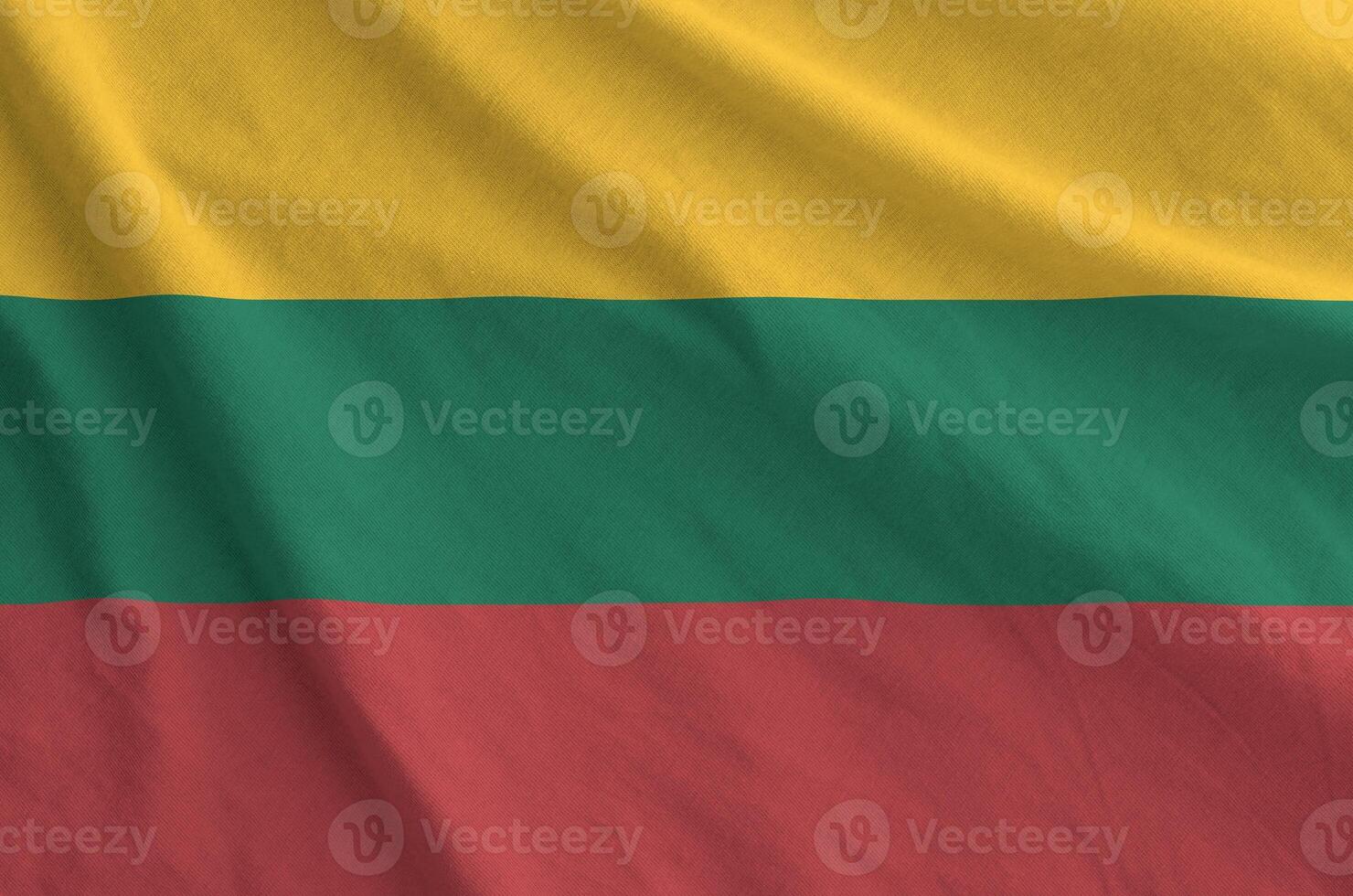 Lithuania flag depicted on folded wavy fabric of old cloth photo