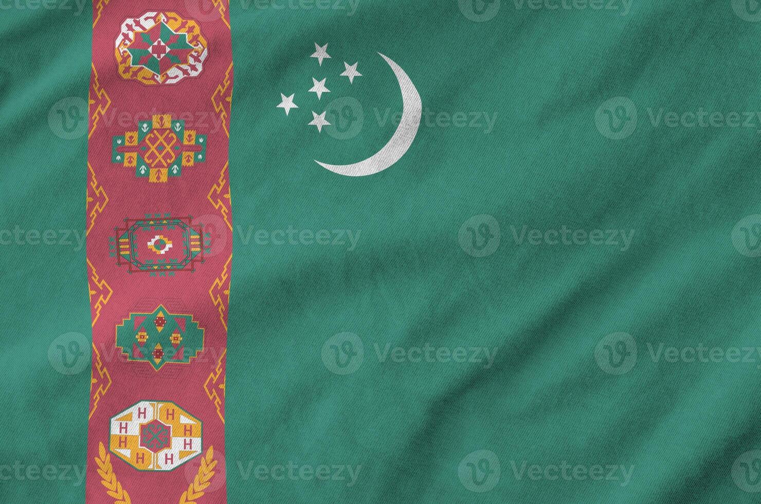 Turkmenistan flag depicted on folded wavy fabric of old cloth photo